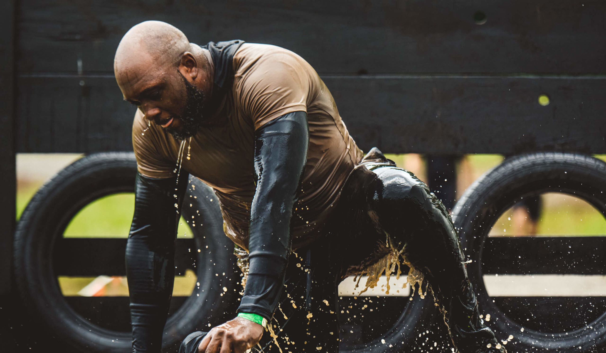 Arctic Enema participant jumping out of ice water.