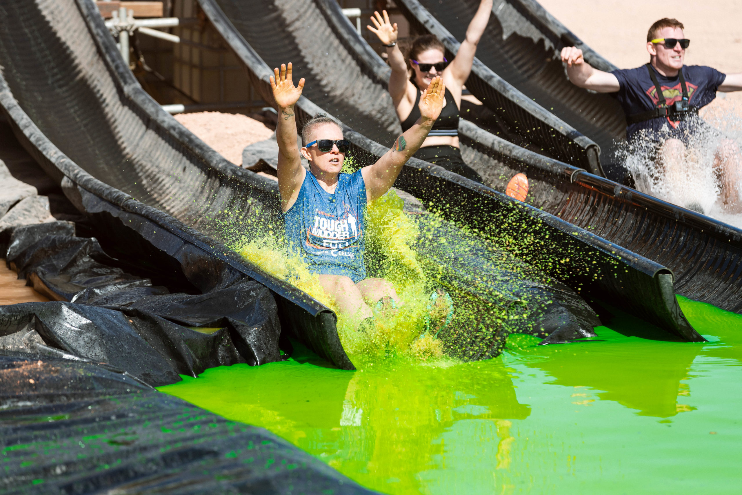 Participants slide into the water