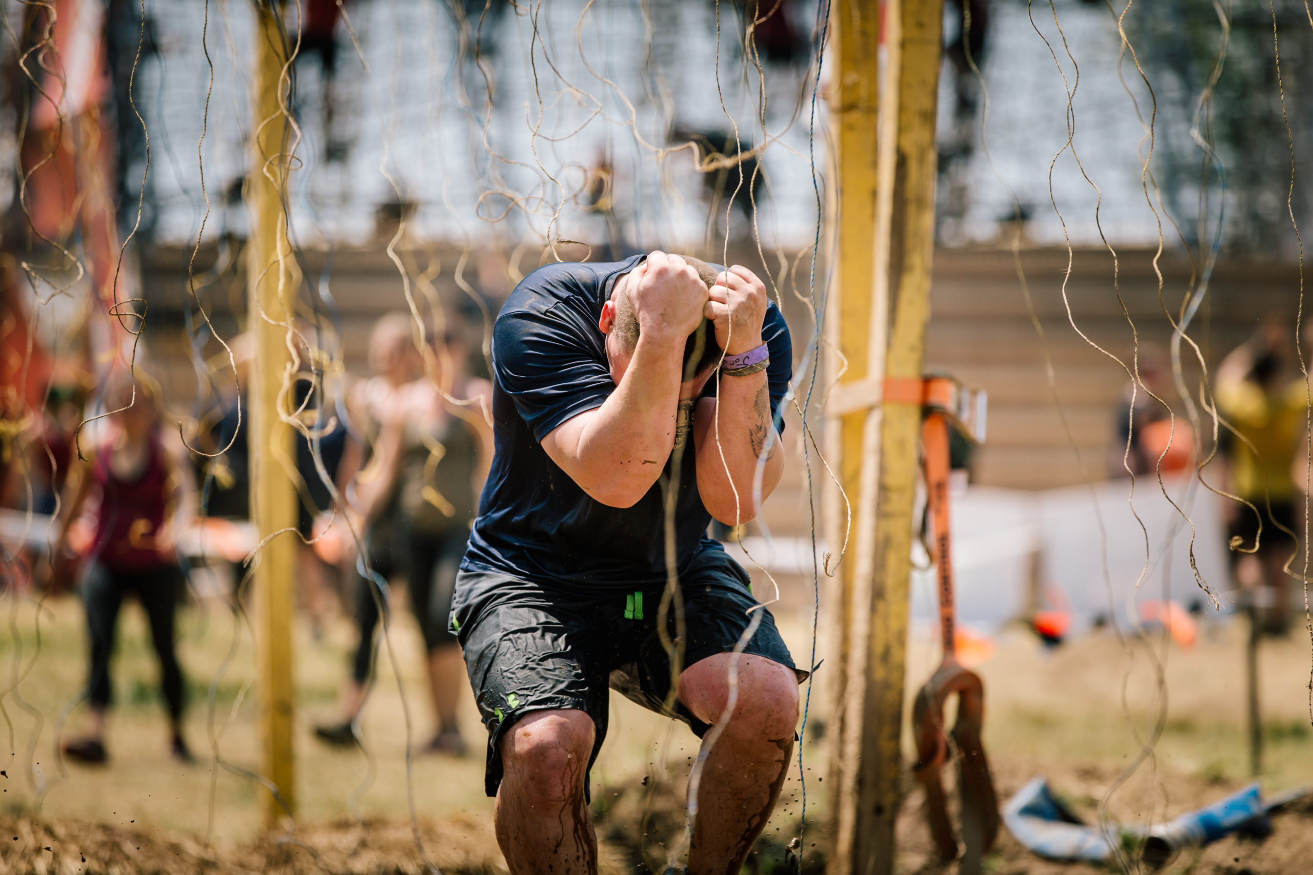 Participant covering his head as he cross Electroshock Therapy