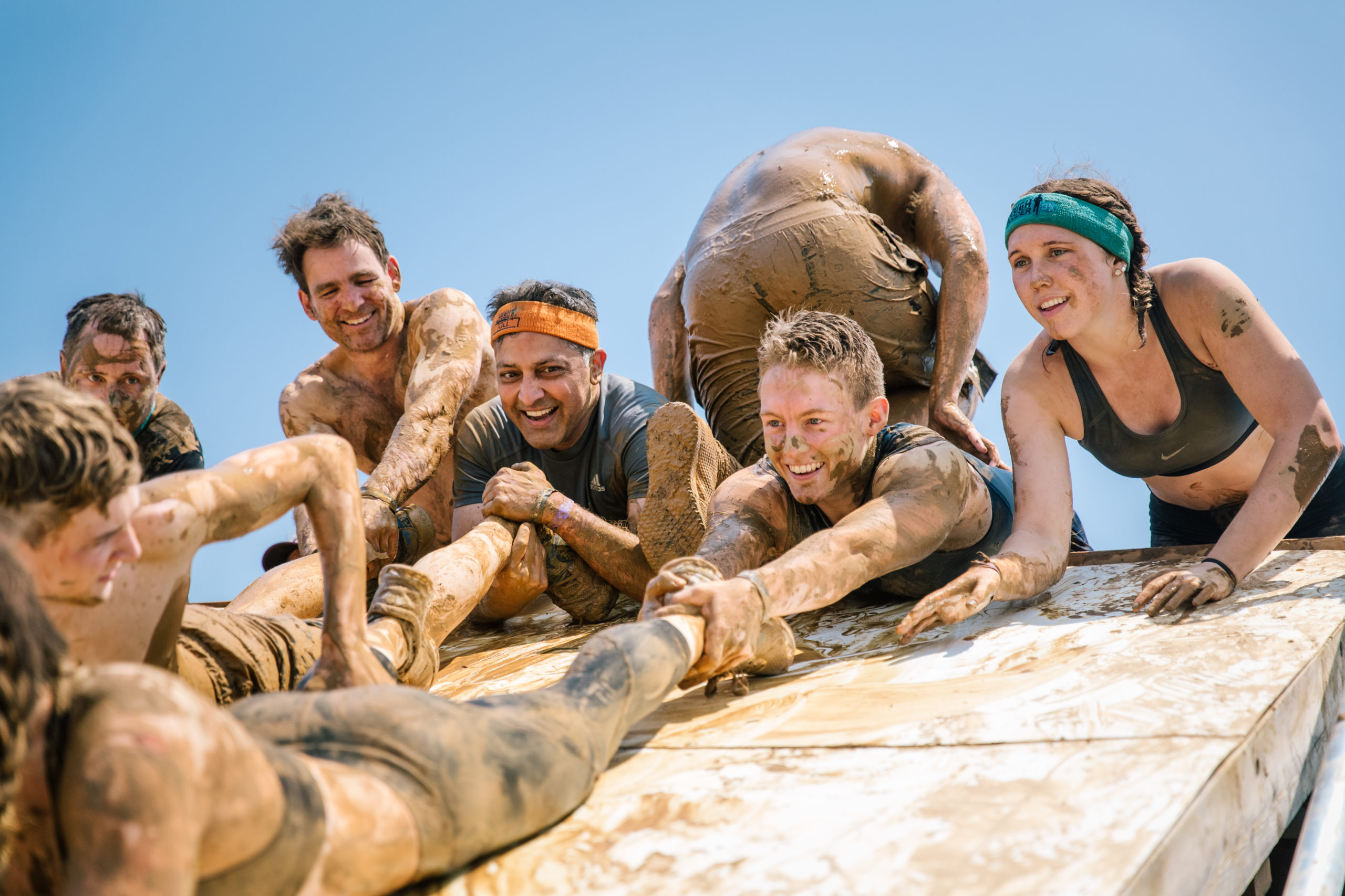 Participants holding their teammate's foot to create 'human rope'