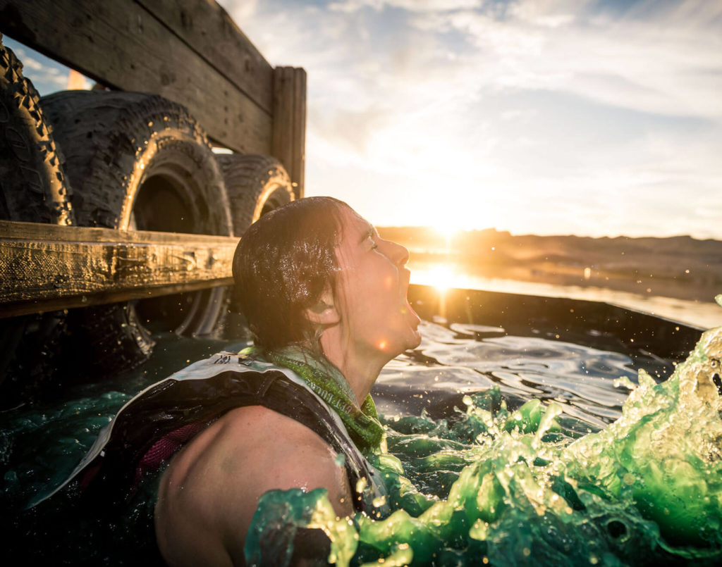 cold water plunge on an obstacle course at sunrise