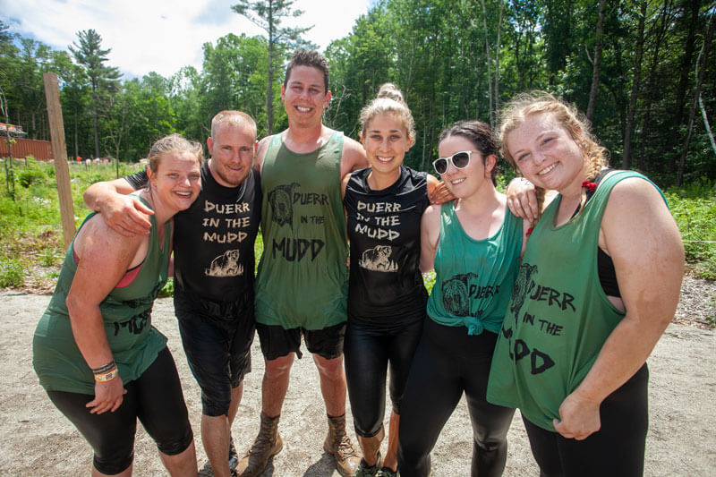 Participants posing for a picture with their arms hugging each other