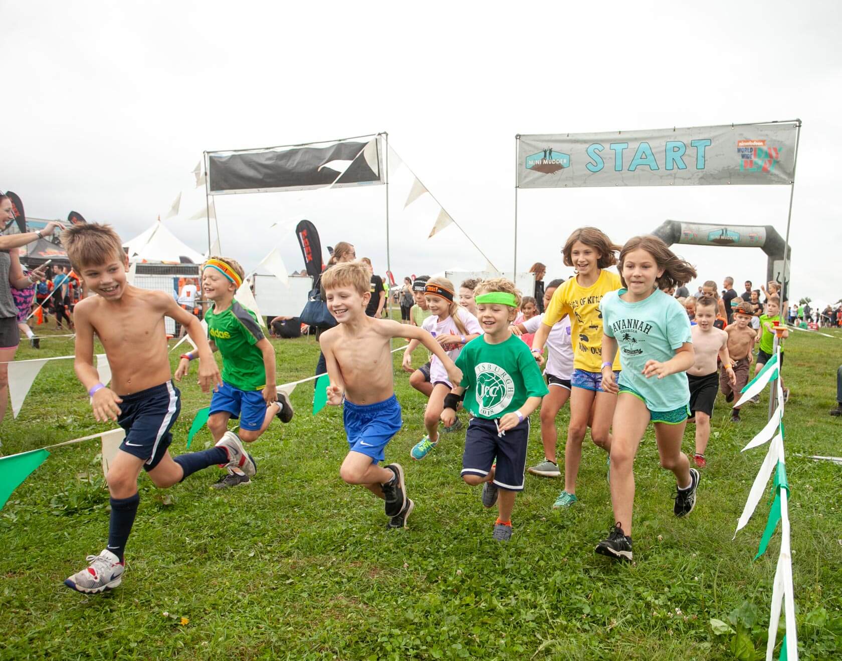 Kid participants excitedly running from the starting line
