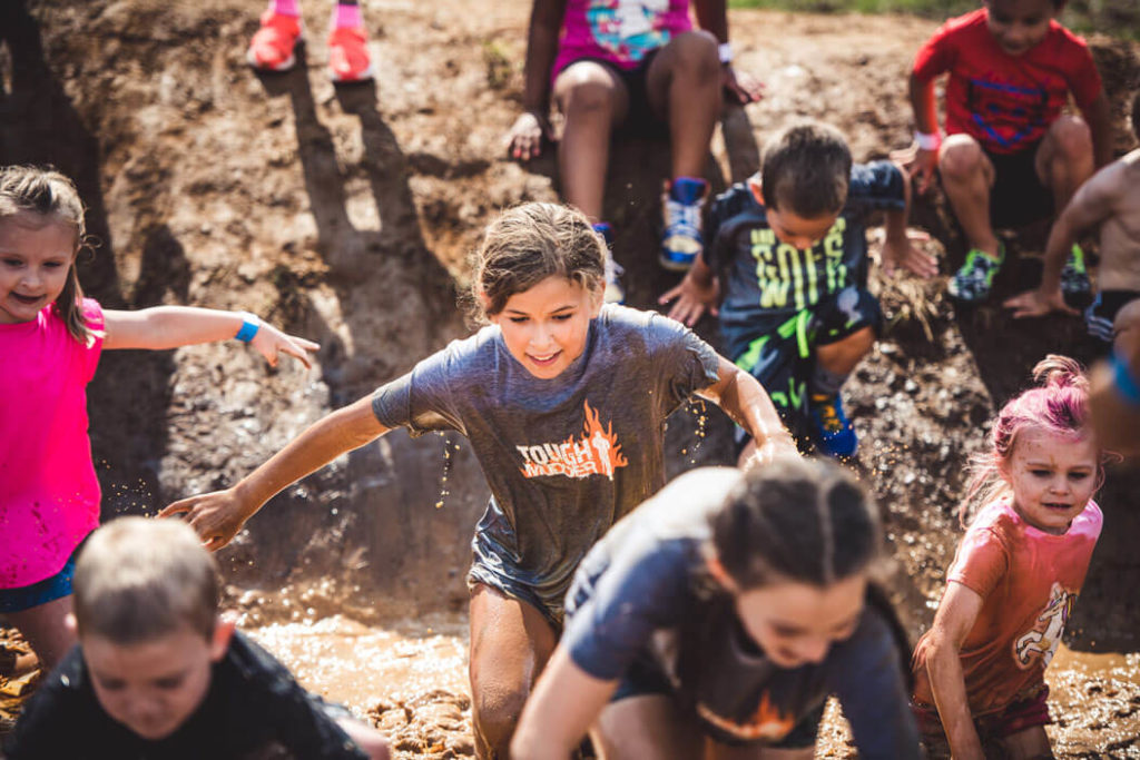 Kid participants running through the mud