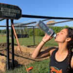 Participant drinking in her water bottle at the front of Electroshock Therapy course