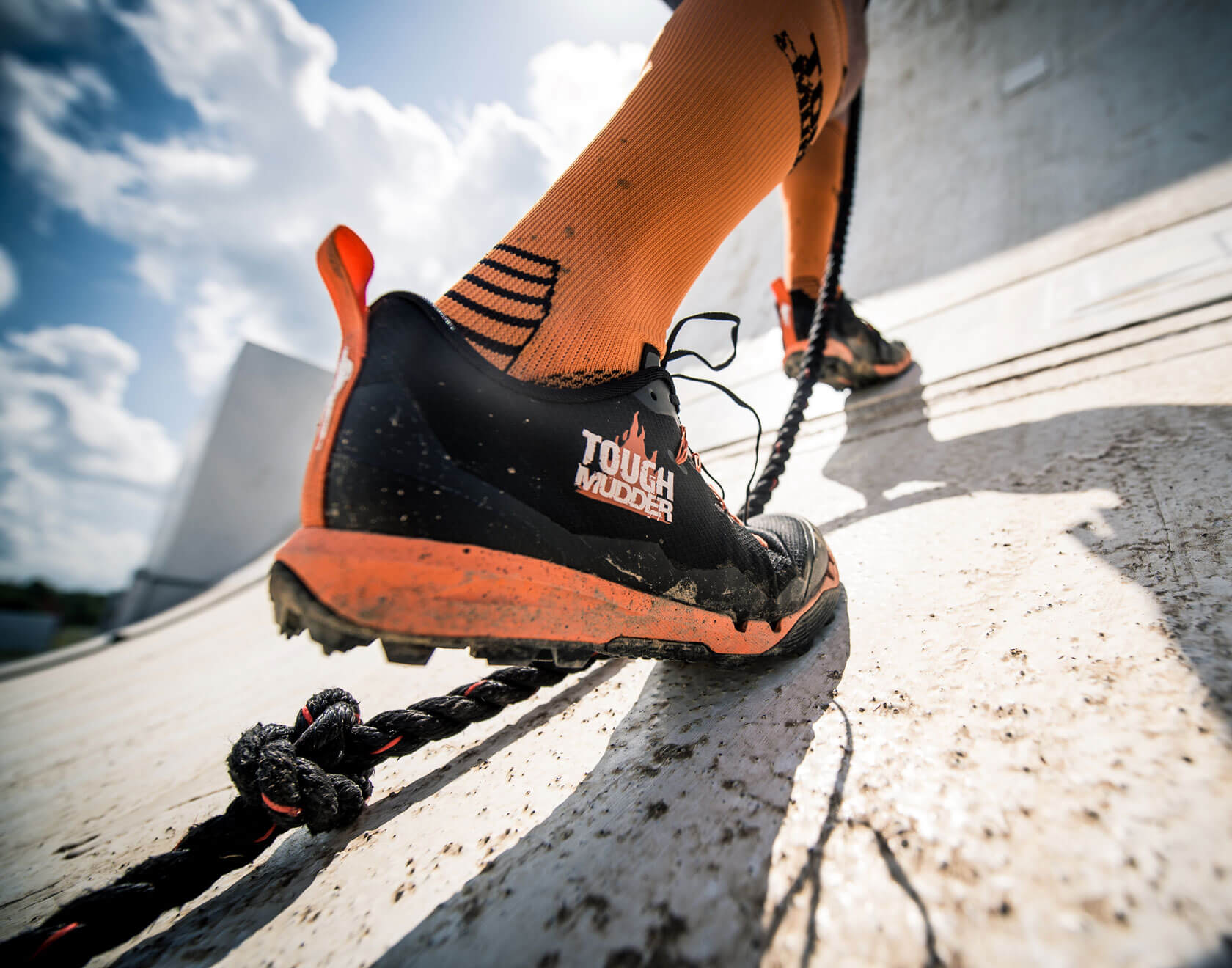 Climbing an obstacle in new Tough Mudder sneakers
