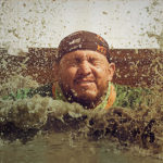Mud waters splash in participant's face