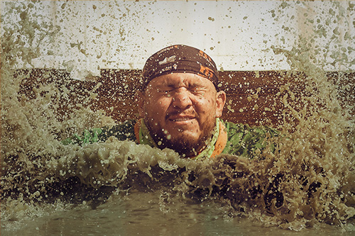 Mud waters splash in participant's face