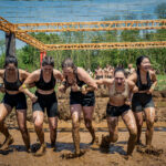 group girls running through obstacle