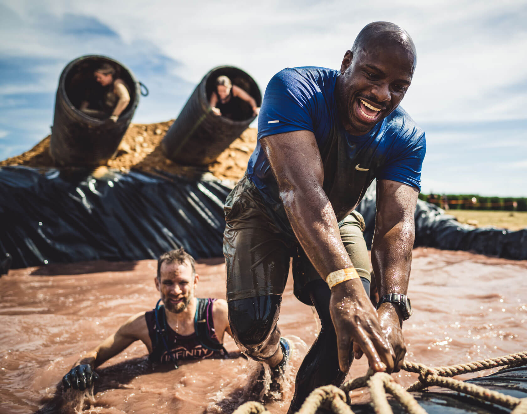 Man smiling as he got out from the muddy water