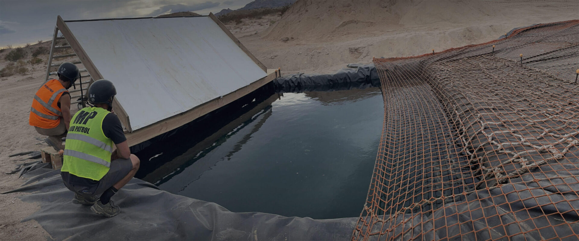 Two people checking on an obstacle setup