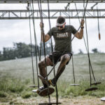 Man struggling to not fall in a rope